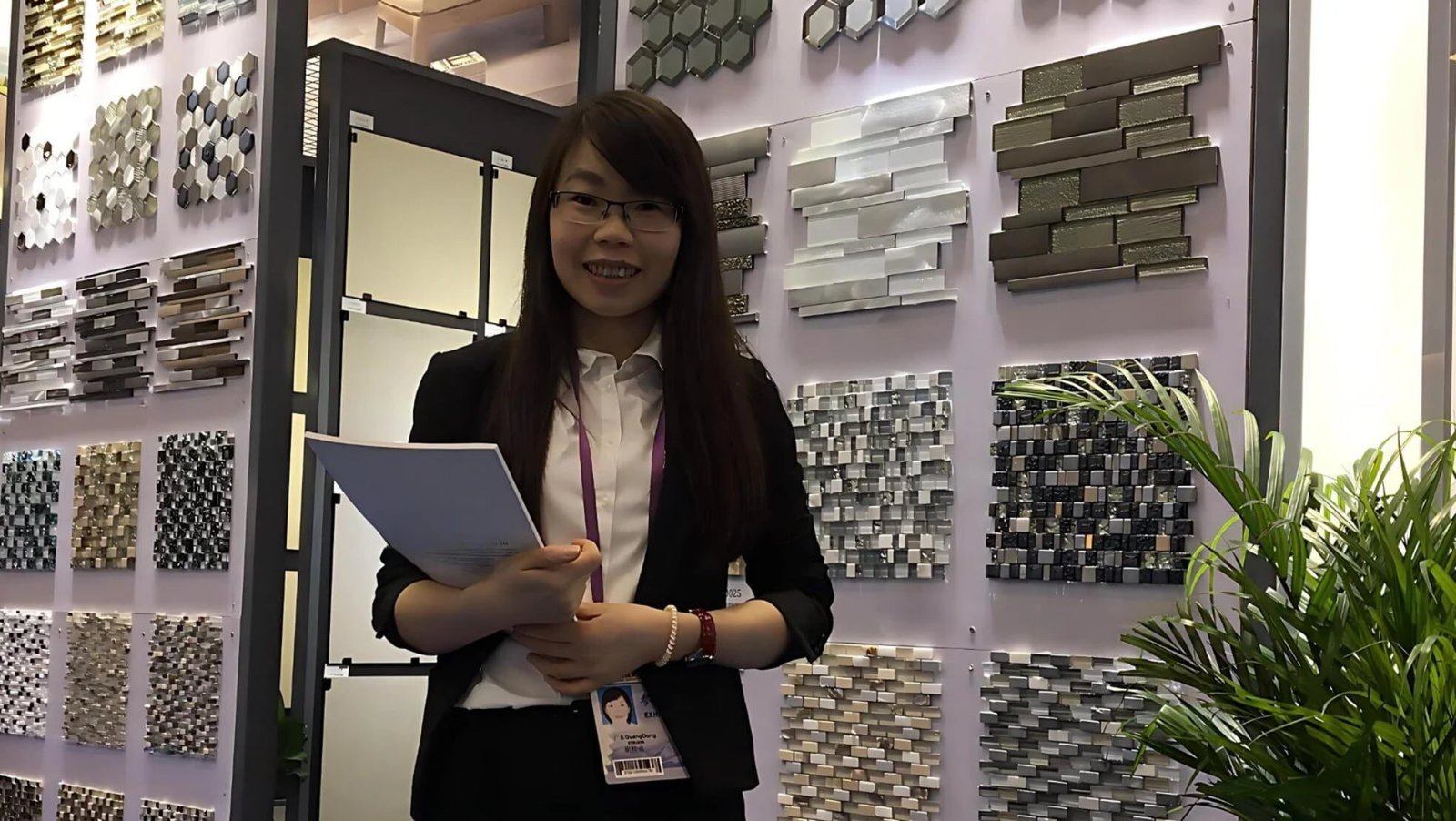 Hands selecting building material samples for export sourcing and product selection